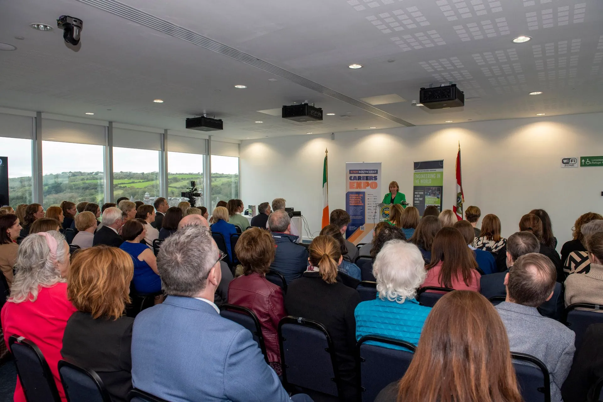 Wide view of the audience seated in the event room